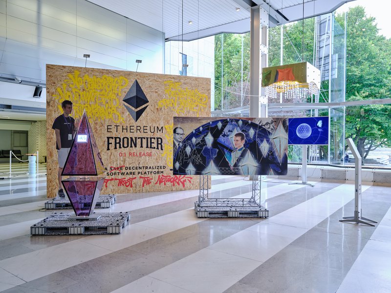 Simon Denny, Blockchain Future States trade fair booth with custom postage stamp: Ethereum [with Linda Kantchev] 2016. Photo Klemen Ilovar / MGLC Archive.